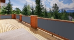 Custom-made waterproof balcony screen in graphite colour mounted on a wooden terrace railing.