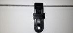 Black plastic stopper for sliding sails and Roman blinds fixed on a steel cable.