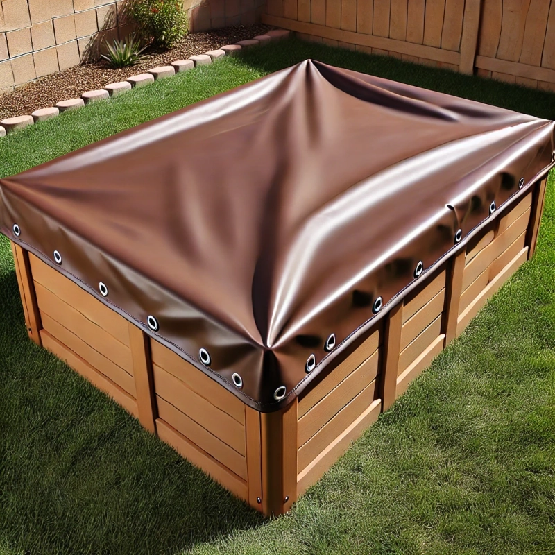 Brown custom-made sandbox tarpaulin with metal eyelets, covering a wooden structure in the garden.