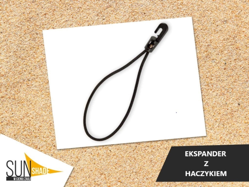 Black rubber expander loop with a plastic hook on a sand background, SunShade brand product.