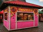 Pink waffle stall protected by a transparent terrace tarpaulin with advertising print, custom-made to measure.