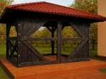 Dark wood garden gazebo with a red roof, located in an orchard on a cobblestone surface.