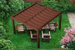 Brown retractable HDPE garden sail made to measure, mounted on a wooden pergola over garden furniture on the lawn.