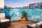 Waterproof made-to-measure balcony screen with ocean marble pattern, mounted on a metal terrace railing.