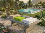 Custom-made protective covers in various colours folded on a concrete garden table by the pool and garden.