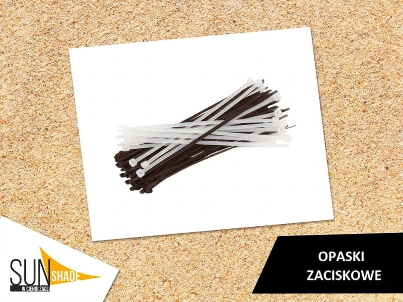 White and black plastic cable ties on a light background, essential for mounting sun visors and shade sails.