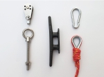 Sailing gear set: pulley, black cleat, carabiner, eye bolt, and red rope with thimble.