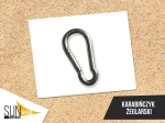 Steel sailing carabiner for mounting a Roman sun sail against a sand background.