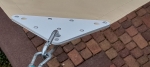 Corner of a custom-made waterproof sun sail with solid steel fitting and mounting carabiner.