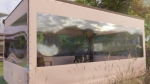 Custom-made beige terrace cover with a large transparent PVC window, protecting the gazebo from wind and rain.