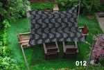 Waterproof 3x3 m sun sail with graphite arches shading garden furniture on a green lawn.