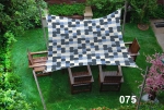 Waterproof 3x3 m garden sun sail with a geometric pattern over a wooden furniture set on a green lawn.