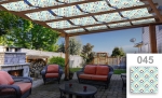 Custom-made sunshade pavilion strip with a modern graphic pattern, mounted on a wooden pergola over the terrace.
