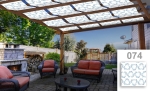 White sunshade sail with a blue graphic pattern mounted on a wooden pergola over the terrace.
