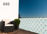 Custom-made Raster balcony screen with geometric patterns, mounted on the railing of a modern terrace.
