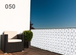 Custom-made white and blue grid balcony screen mounted on a terrace railing with a dark armchair.