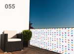 Custom-made raster balcony screen with colourful patterns, mounted on a balcony railing with a chair and a plant.