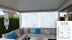 Custom-made net curtain with a light blue lip pattern, hanging on a modern terrace with a grey corner sofa.