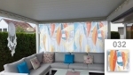 Custom-made net curtain with colourful graphic 032, hung on a modern terrace over a grey corner sofa.