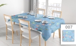 Custom-made blue promotional tablecloth with colourful flowers on a set table in a bright dining room with white chairs.